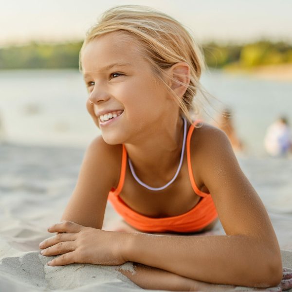 Little,Beautiful,Smiling,Girl,Lying,On,The,Sand,At,The